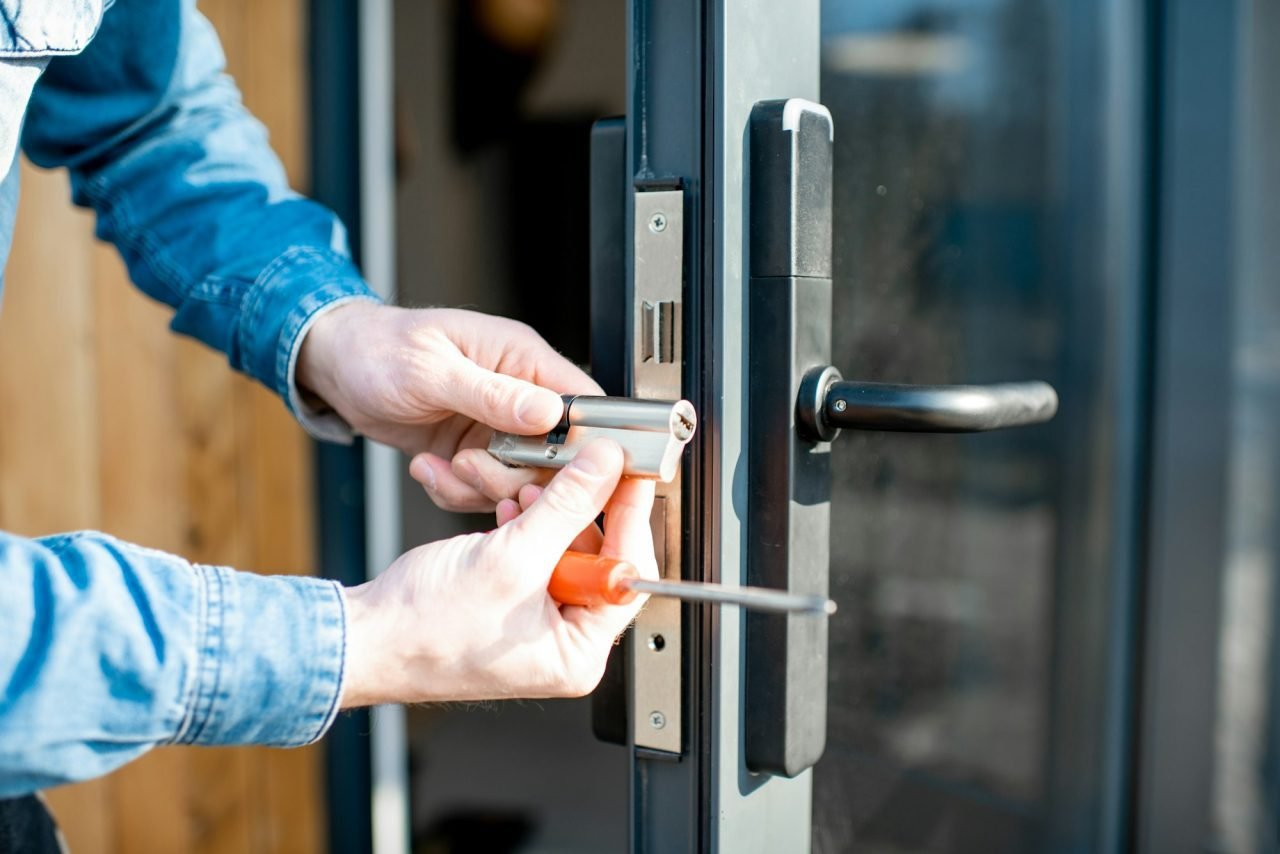Locksmith changing the lock core on a residential security door